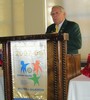 District Governor Stan Smalley at podium with RI banner